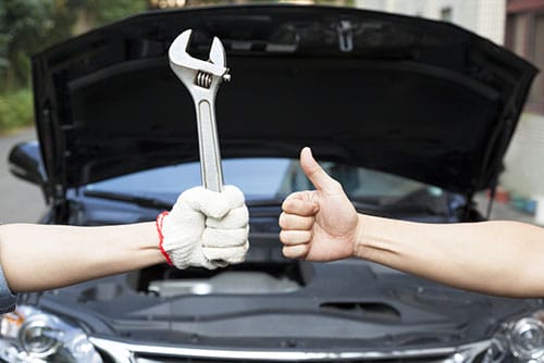 Trusted mobile mechanic in Jackson MS holding a wrench and giving a thumbs up for reliable car repair