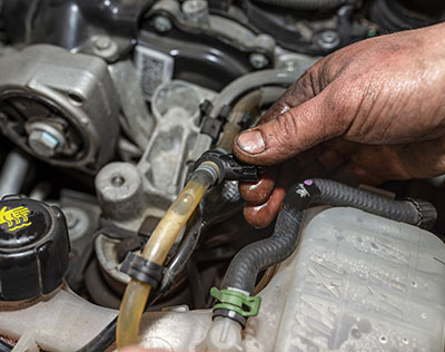 Mobile mechanic in Jackson MS inspecting fuel lines during a fuel pump repair