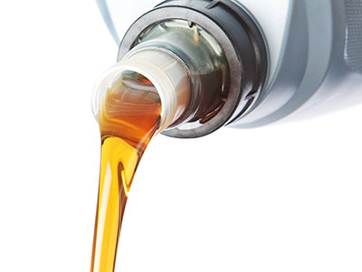 Fresh engine oil being poured during a mobile oil change service in Jackson MS
