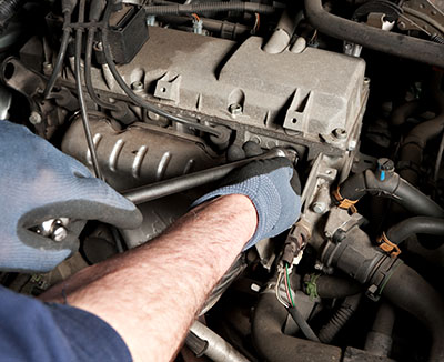 Mobile mechanic in Jackson MS inspecting engine components during a car tune-up service